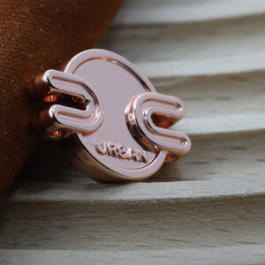 Polished metal garment badge for fashion branding applications