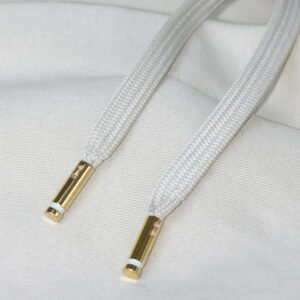 Metal aglets applied to white garment drawcords