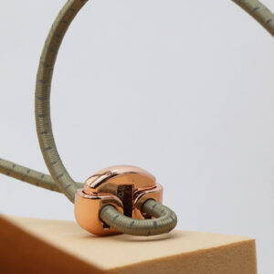 Metal cord lock detail used on elastic drawcord trims