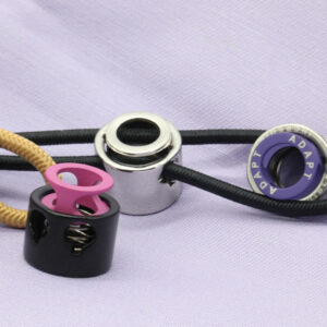 Mixed cord stopper components for functional garment adjustment