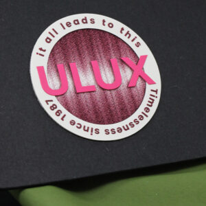 Round heat transfer label for branded apparel detailing