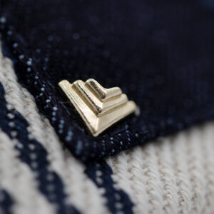 Decorative rivet detail for branded apparel trims