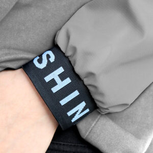 Wide woven strap detail with raised logo branding