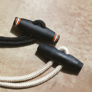 Black toggle components for adjustable cord and fastening systems