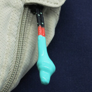 Colour-accent zipper pull attached to technical fabric